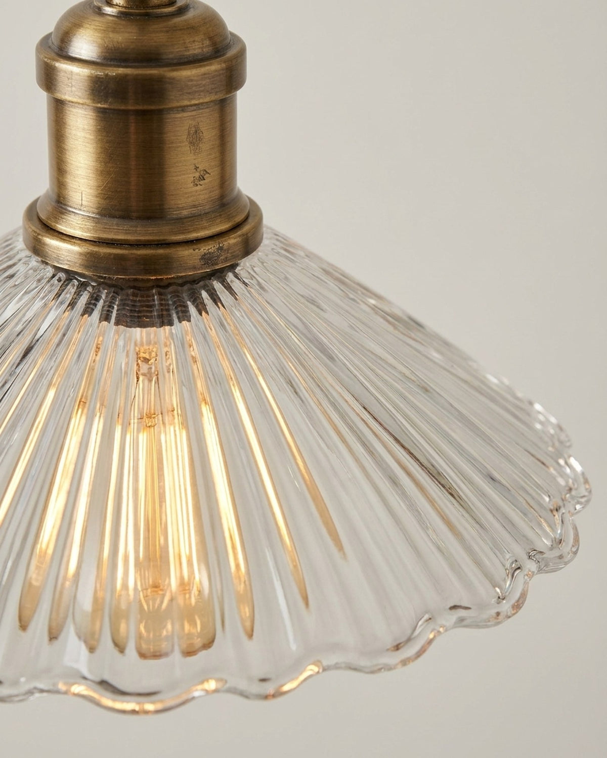 Clear fluted glass, on aged brass.
