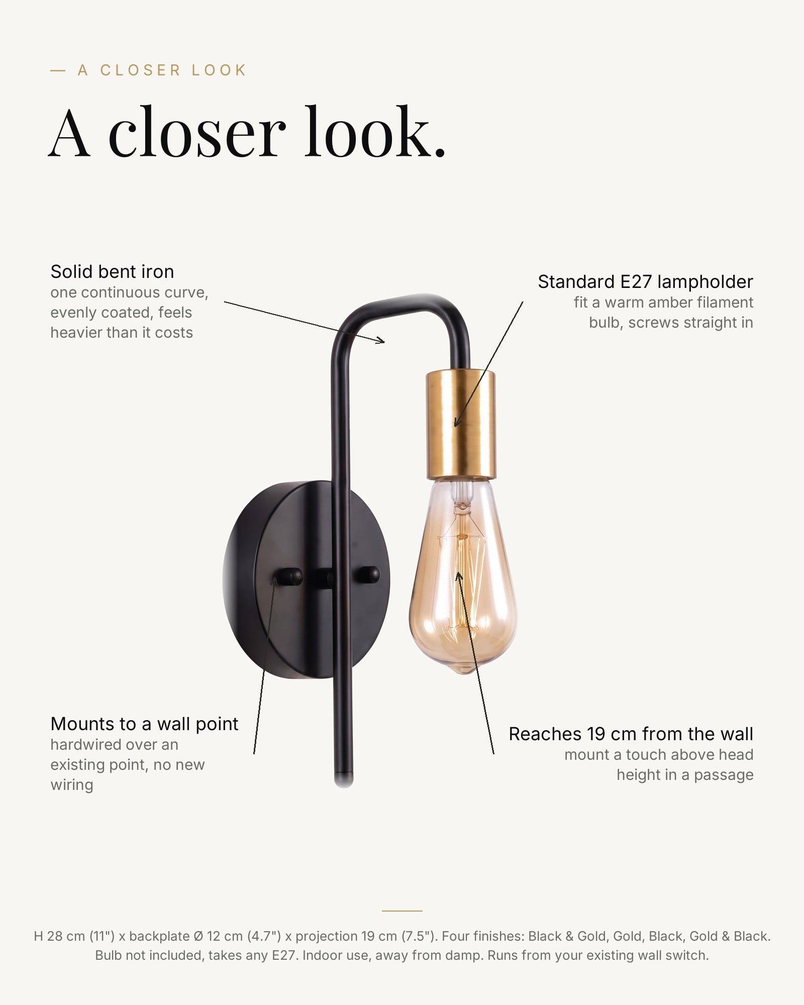 A closer look at the black and gold bare-bulb wall light: solid bent iron arm, brass E27 lampholder, mounts to an existing wall point, reaches 19 cm from the wall