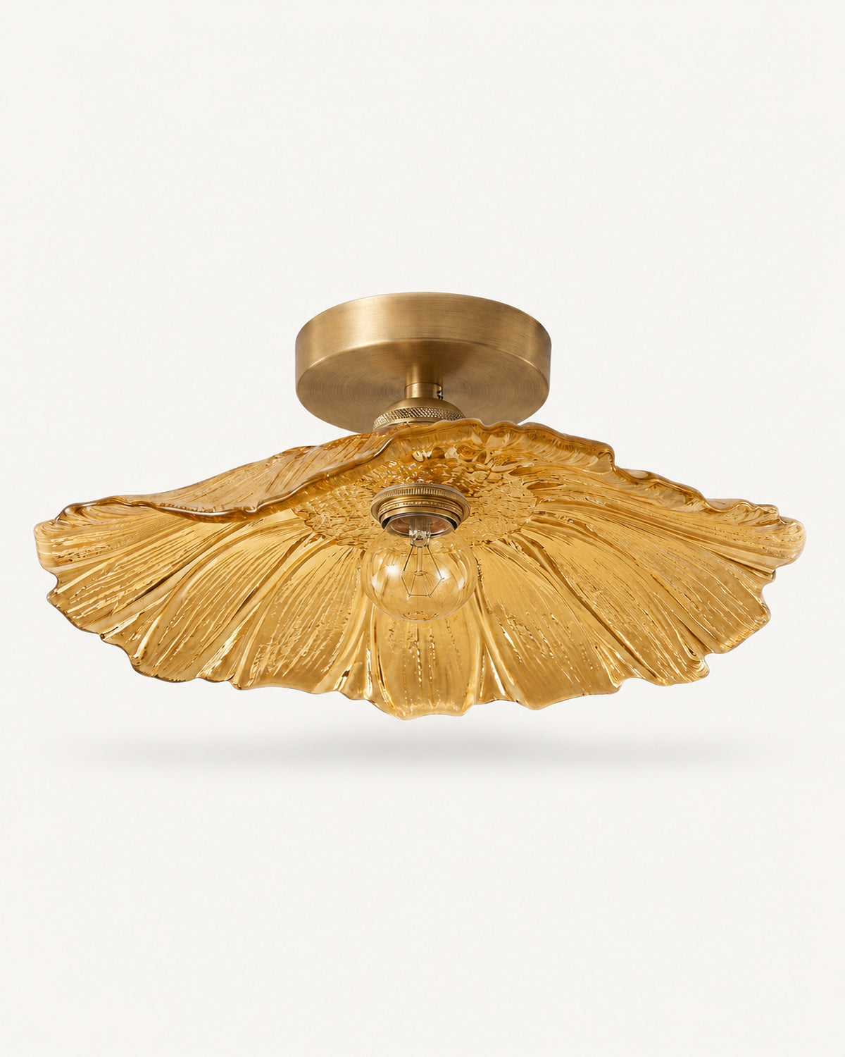 Antique brass semi-flush ceiling light with an amber fluted petal glass shade