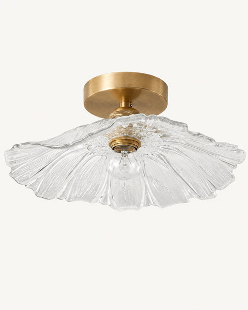 Antique brass semi-flush ceiling light with a clear fluted petal glass shade