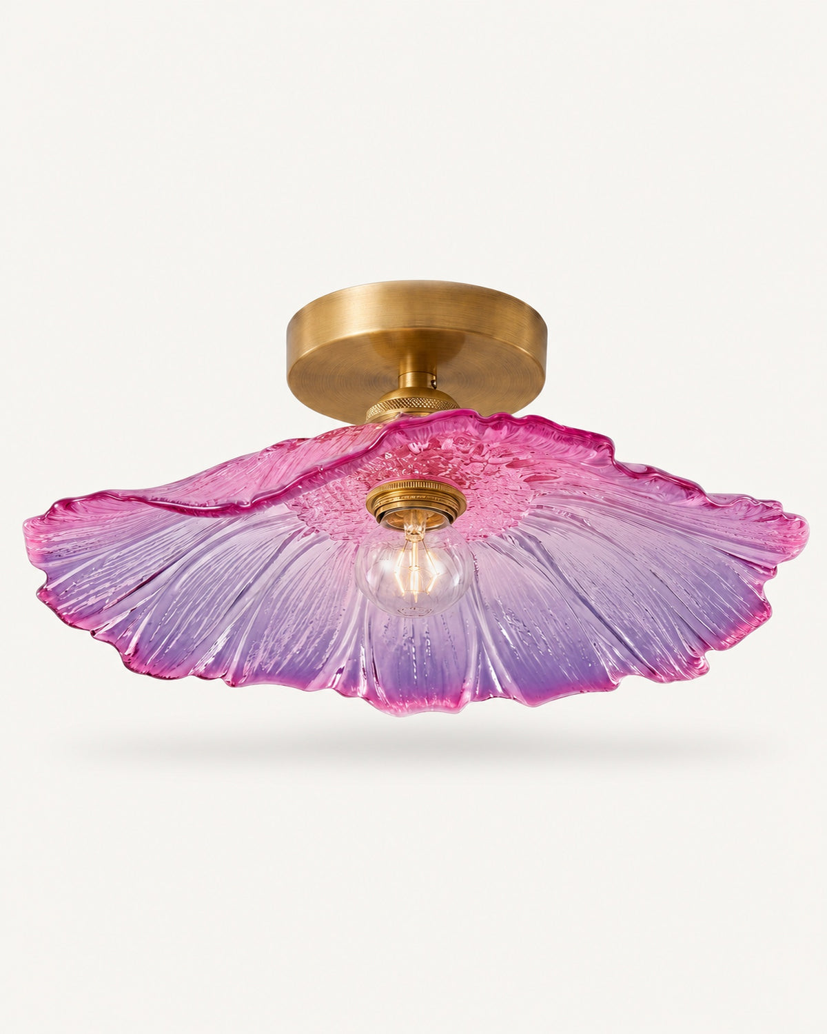 Antique brass semi-flush ceiling light with a purple and pink fluted petal glass shade