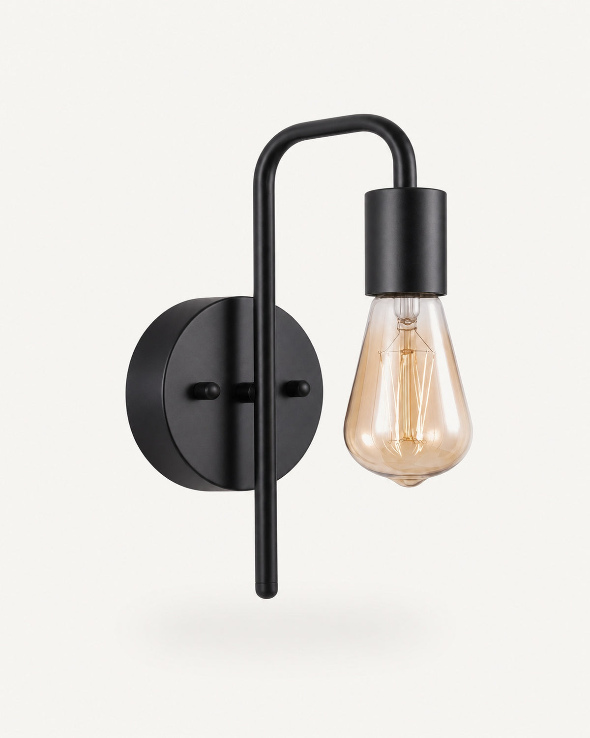 Bare bulb industrial wall light in all black: matte black arm, backplate and socket, amber Edison bulb