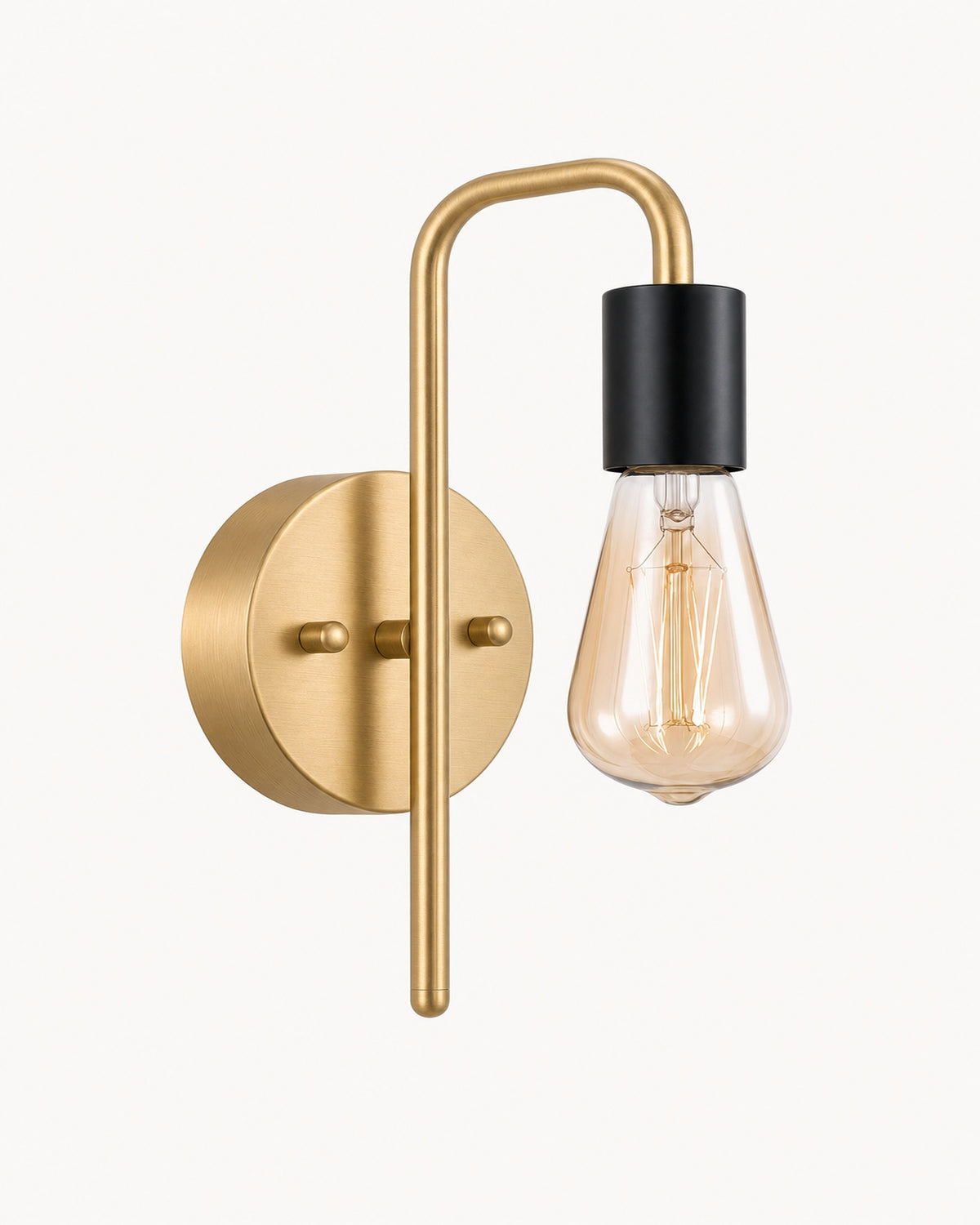 Bare bulb industrial wall light in gold and black: brushed gold arm and backplate, matte black socket, amber Edison bulb