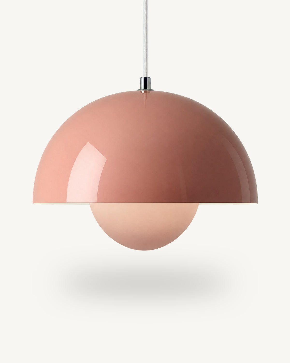 Modern iron dome pendant light in Pink, its painted metal sphere sitting level with the shade rim