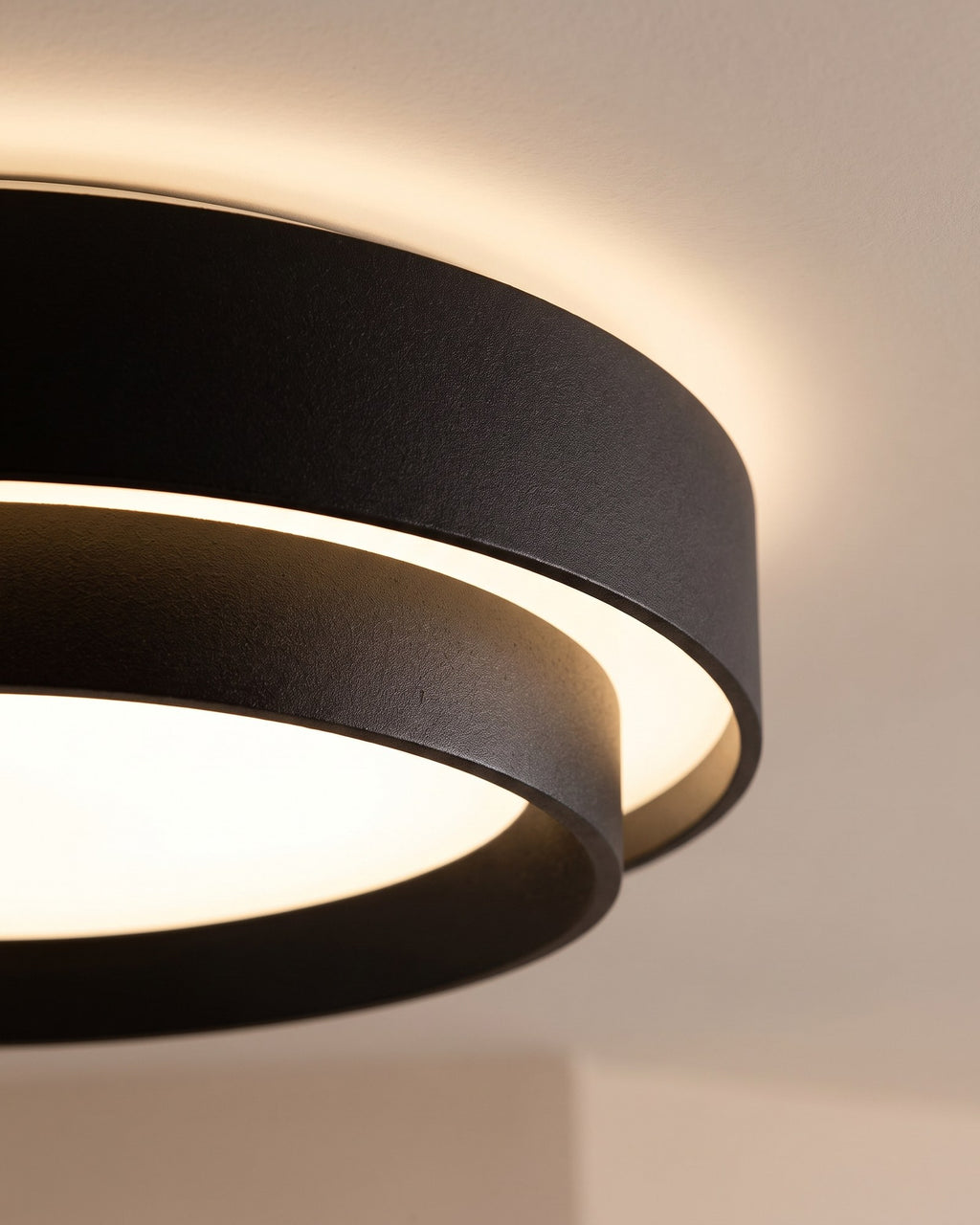 Macro of the matte black drum rim and the warm glow between its two rings