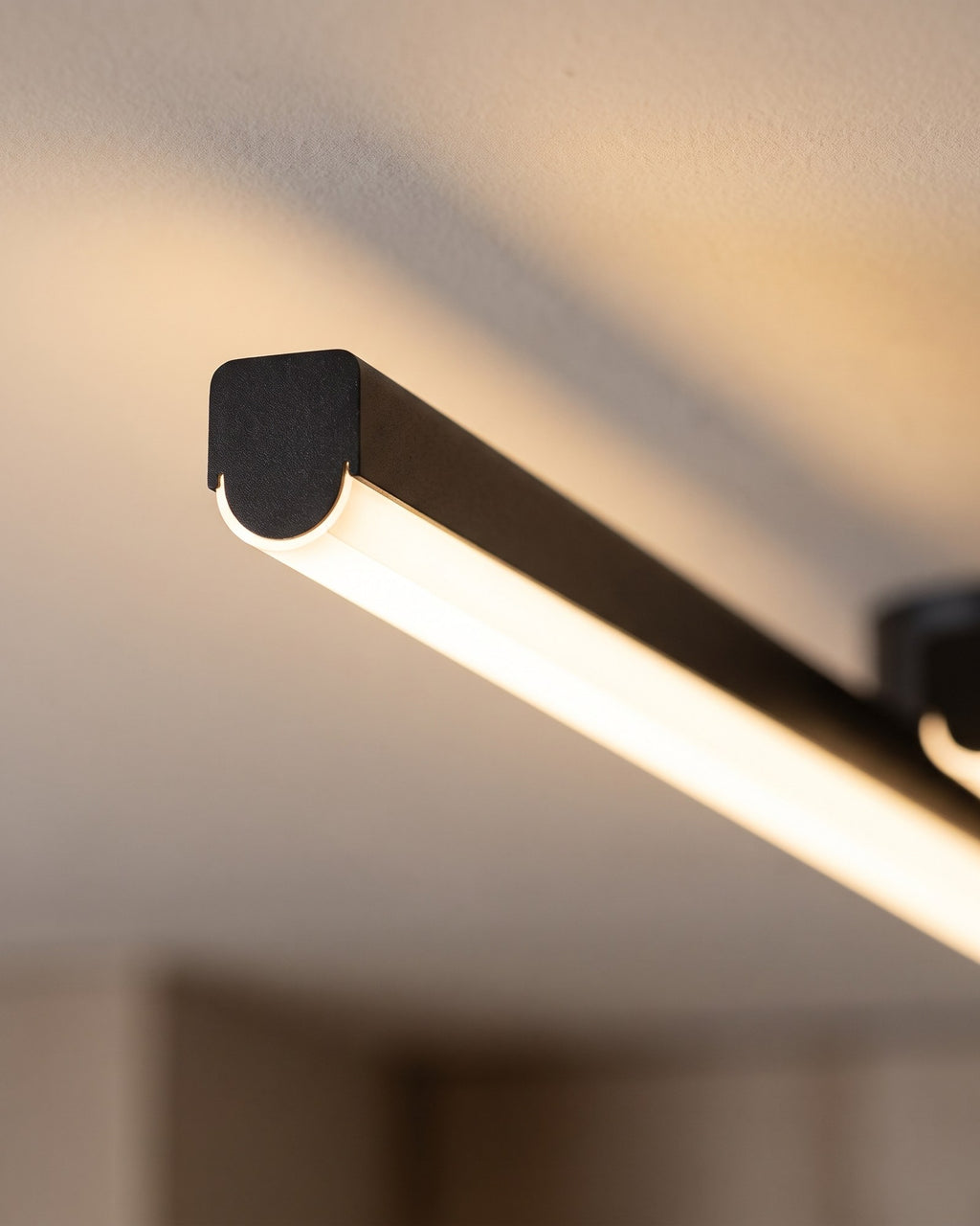 Macro of the matte black aluminium bar and its warm LED diffuser line