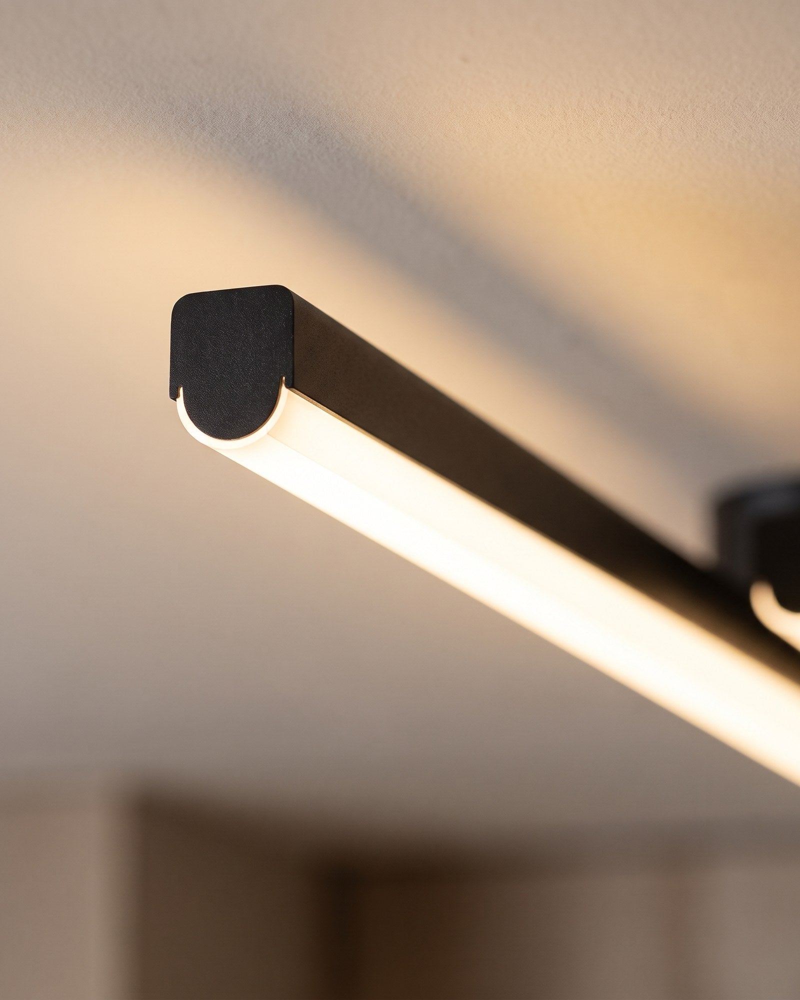Macro of the matte black aluminium bar and its warm LED diffuser line