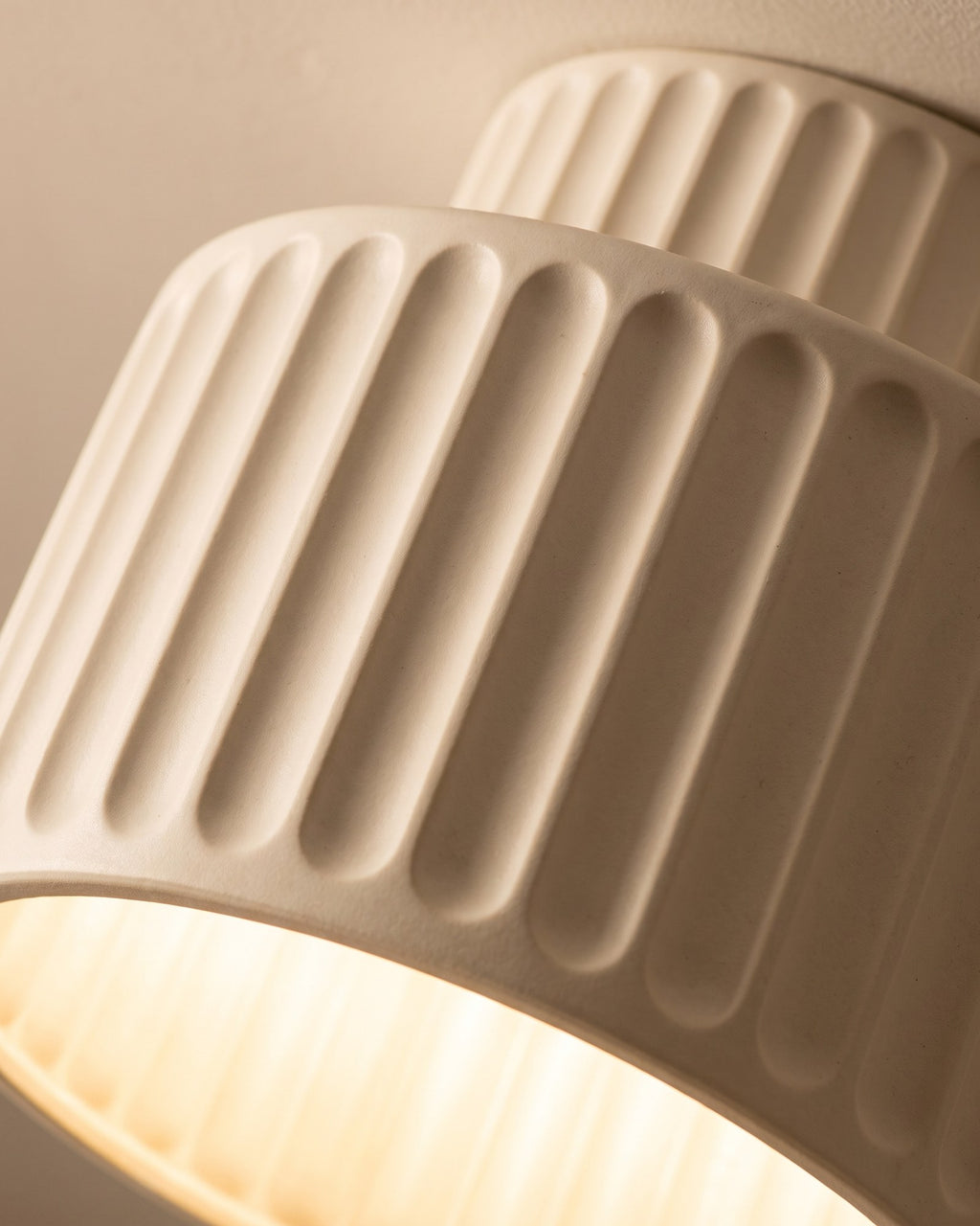 Macro of the deep cream pleats and the warm glow through the open base