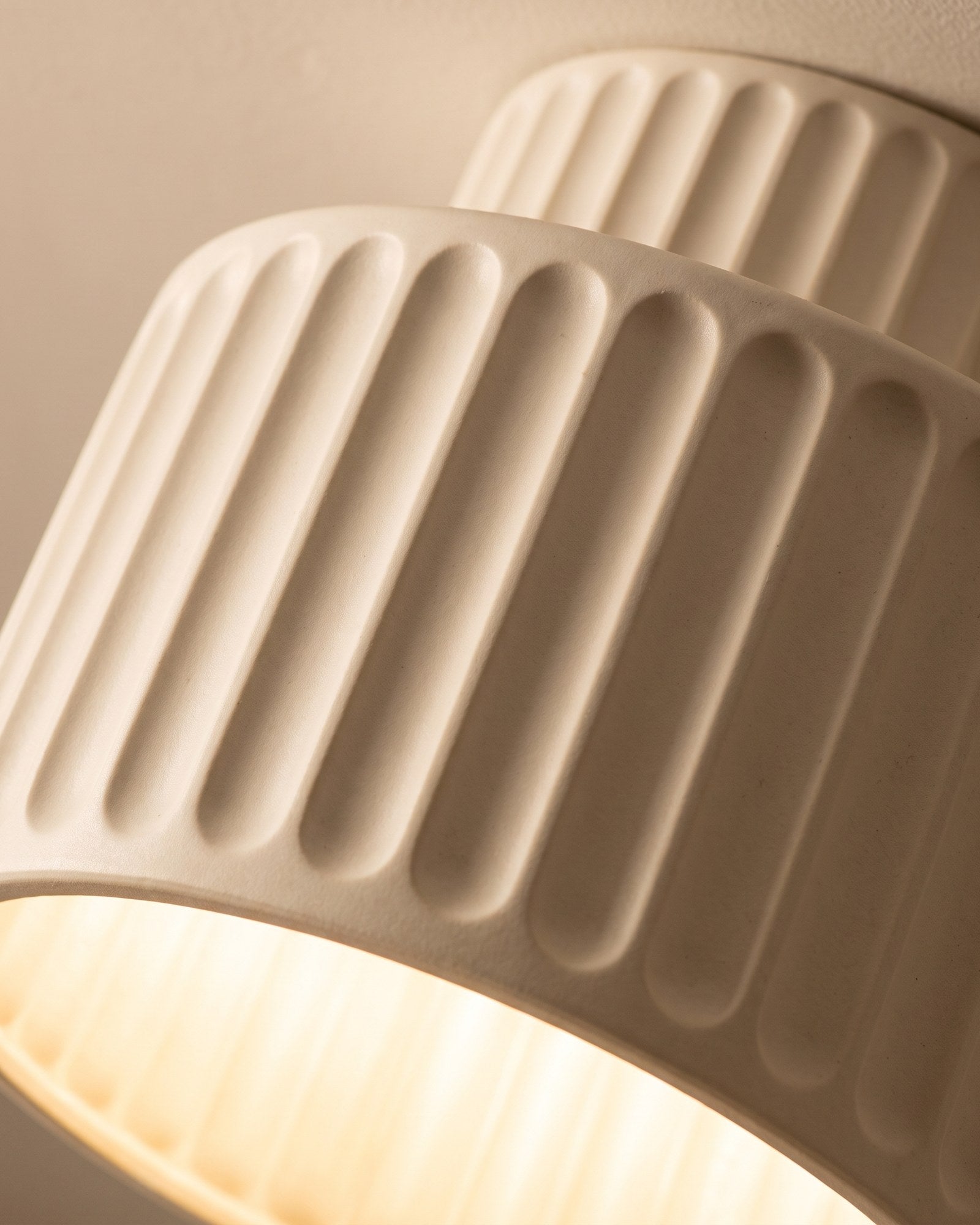 Macro of the deep cream pleats and the warm glow through the open base