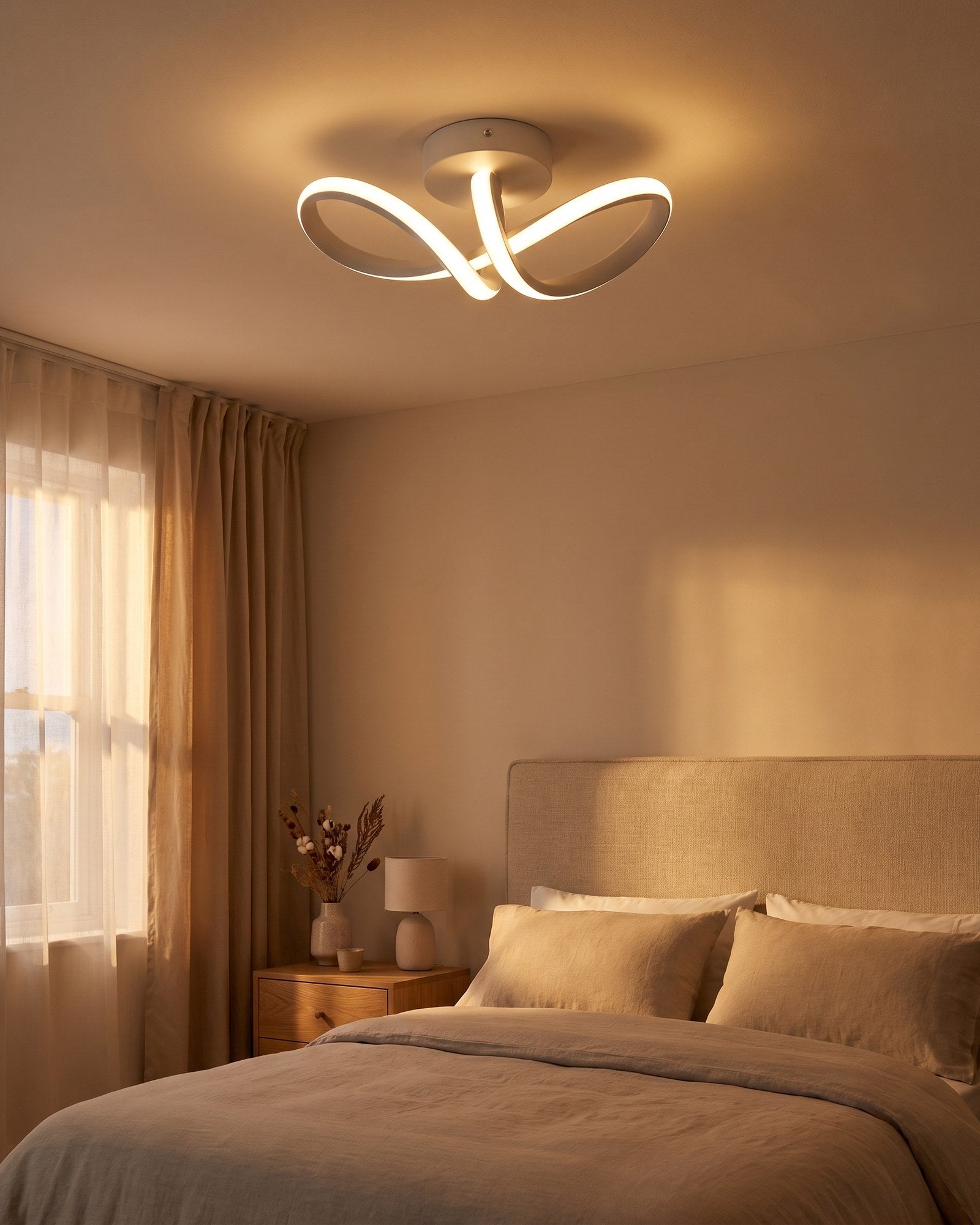 White curved ribbon LED ceiling light glowing warm in a bedroom at early evening
