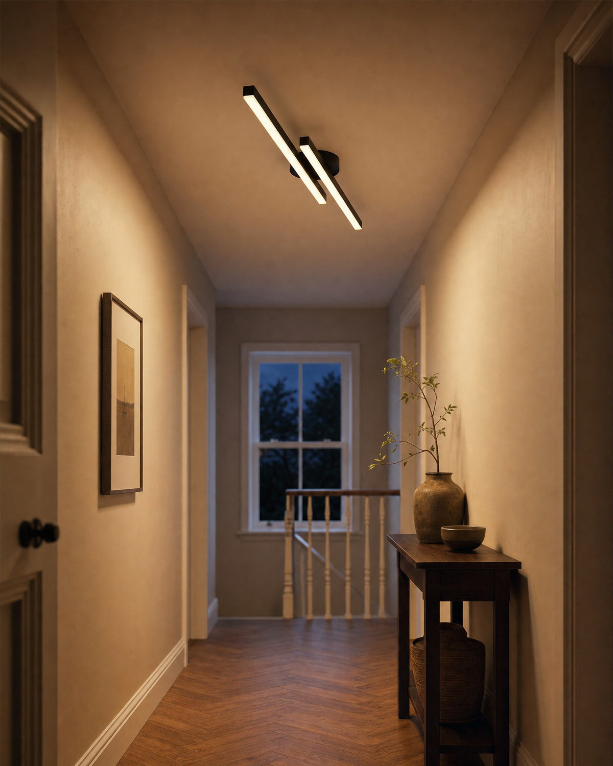 Twin bar LED flush ceiling light in black, glowing warm along a British landing at dusk
