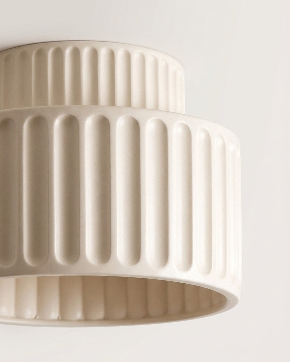 Pleated like thrown ceramic.